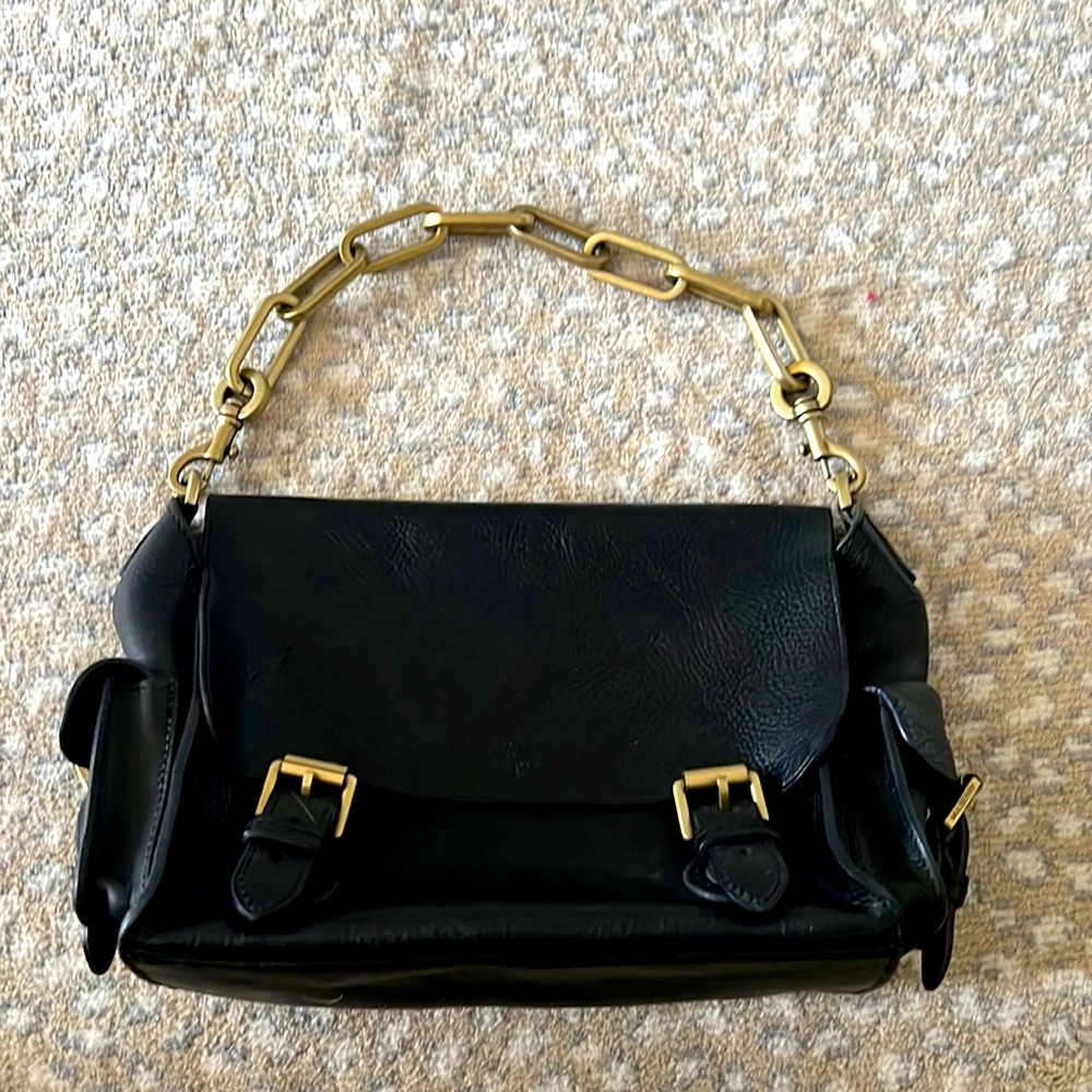 Black leather bag with a gold chain strap